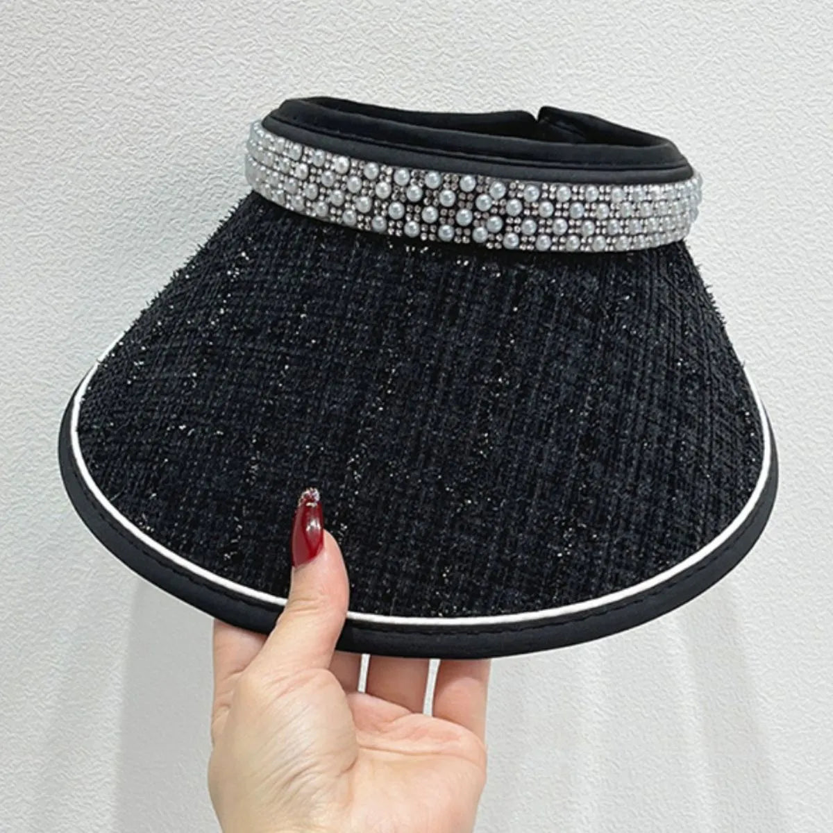 Black tweed visor with pearl and rhinestone embellishment on the band.