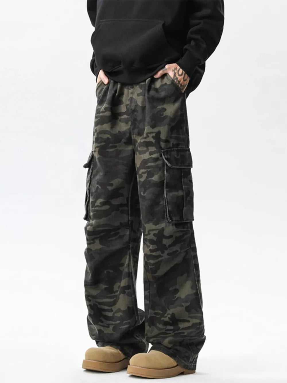 Relaxed fit dark camo cargo pants with multiple pockets.