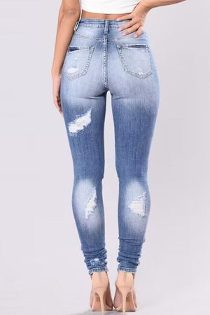 Light wash ripped knee skinny jeans with a sculpting fit.