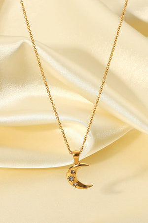Gold crescent moon pendant necklace with star accents on a delicate chain.