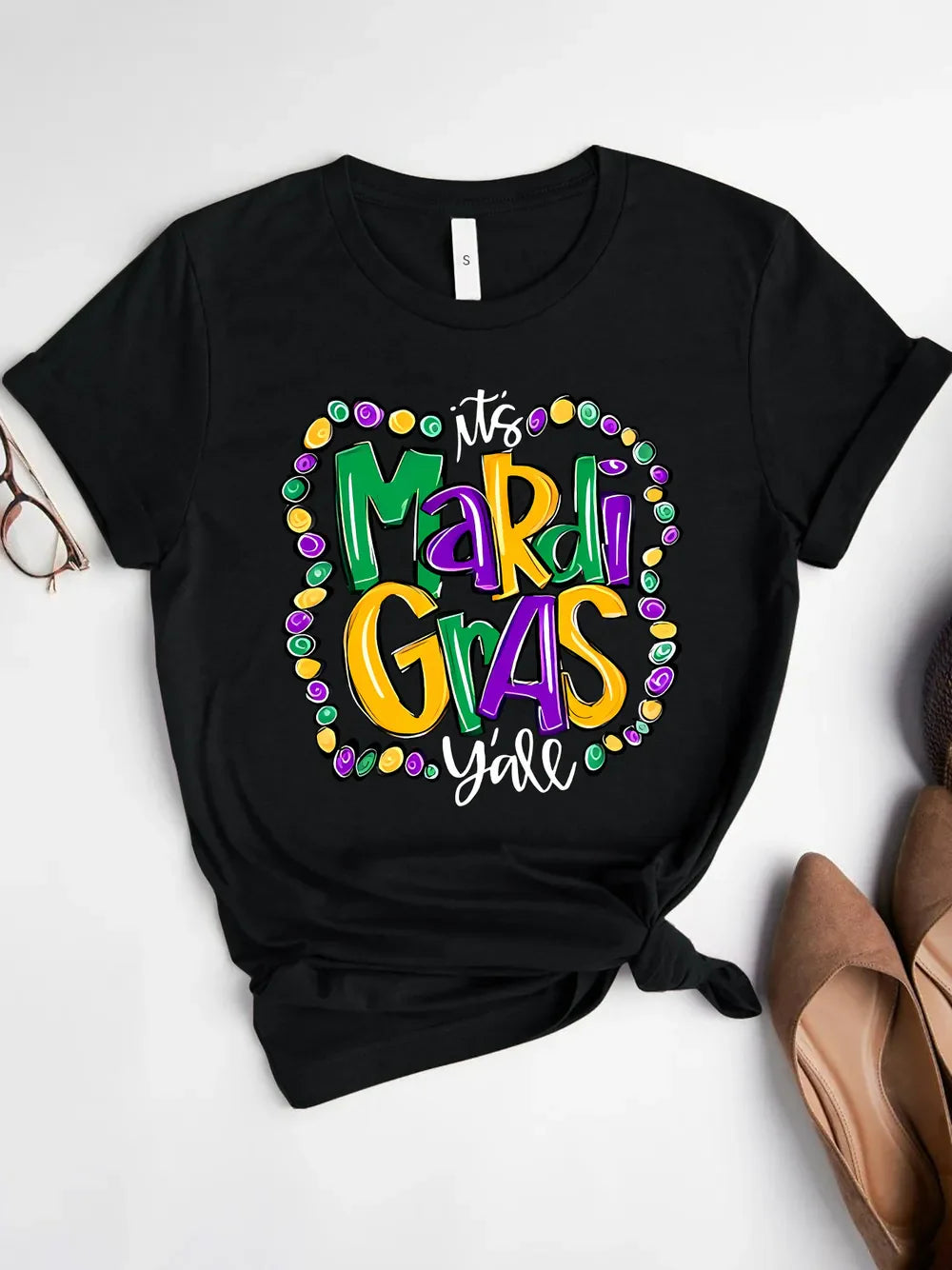 Black graphic t-shirt with Mardi Gras beads and text design.