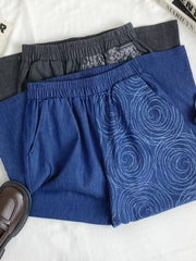 Blue comfort jeans with rose print and grey jeans with paisley print detail.