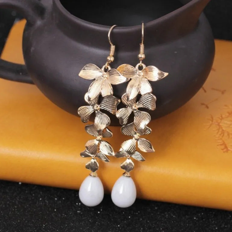 Gold cascading flower drop earrings with white pearl accents