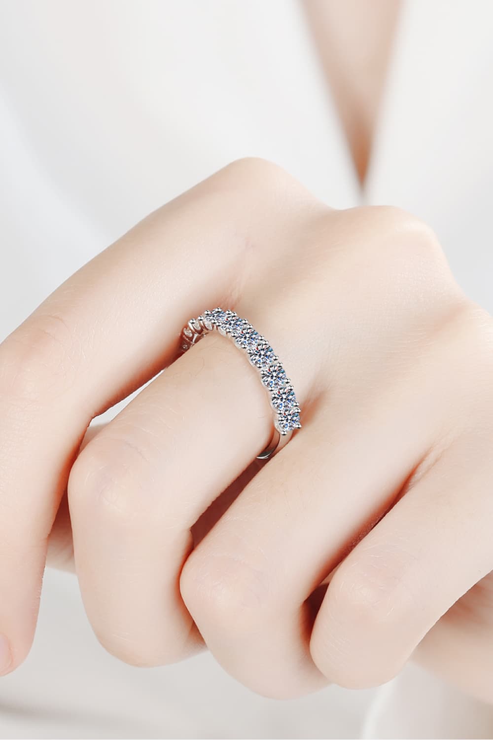 Silver eternity band ring with a row of sparkling moissanite stones.