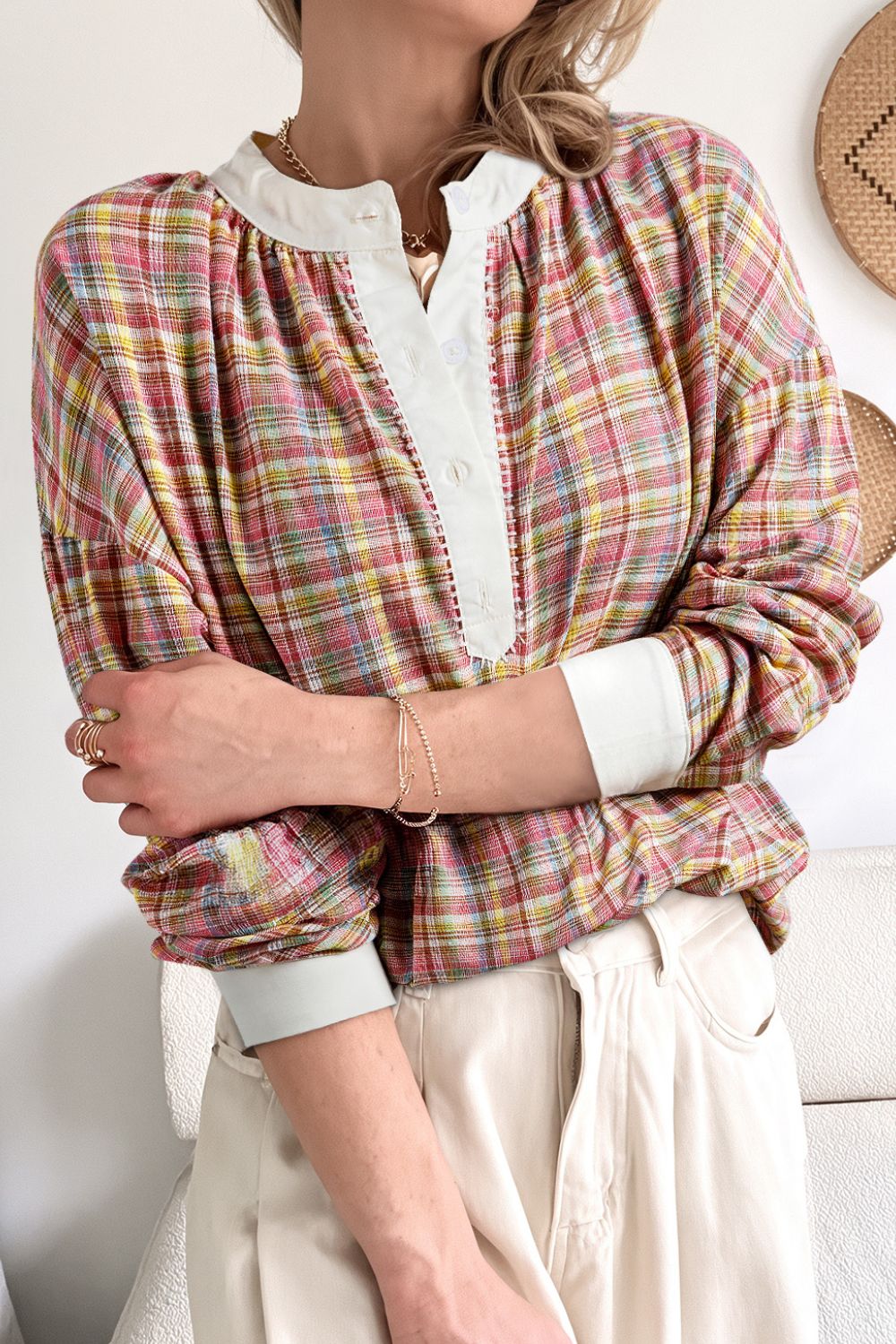 Bohemian plaid blouse with mandarin collar and buttoned placket, in dusty pink hues.