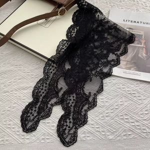 Black delicate floral lace scarf with scalloped edges.