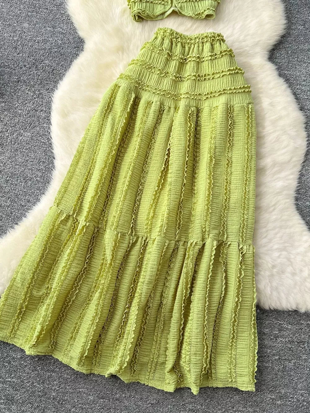 Light green textured two-piece set with ruffled details and tiered skirt.