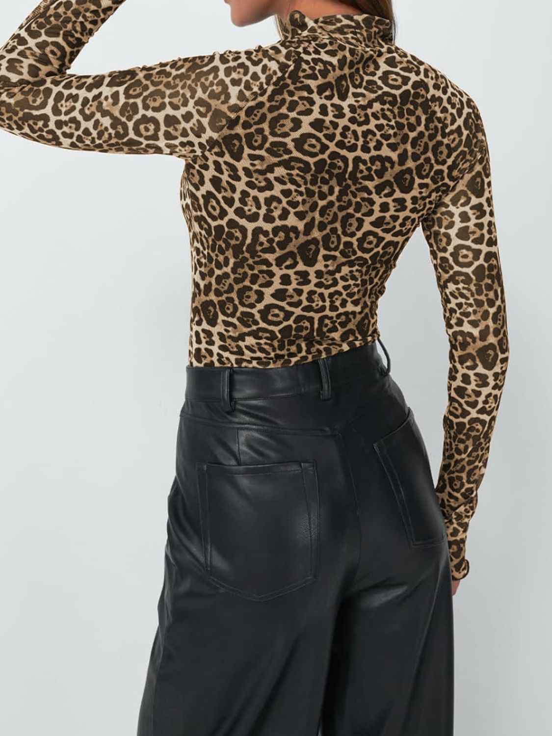 Leopard print mesh second-skin top with mock neck and long sleeves.