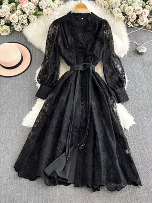 Black lace maxi dress with balloon sleeves, tie waist, and button front.