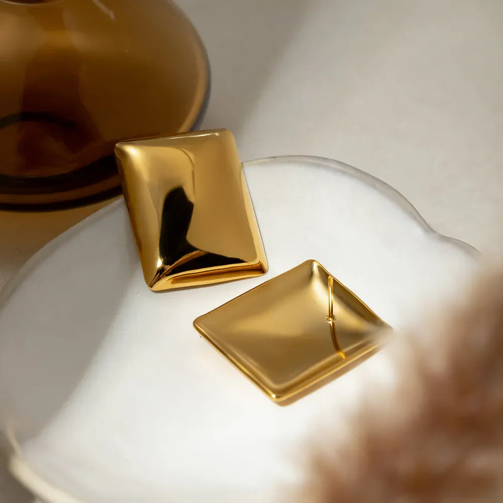 Sculpted gold rectangle earrings with a polished finish.