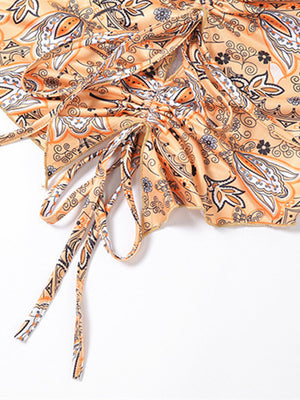 Paisley print halter top in tangerine with ruched detail and tie strings.