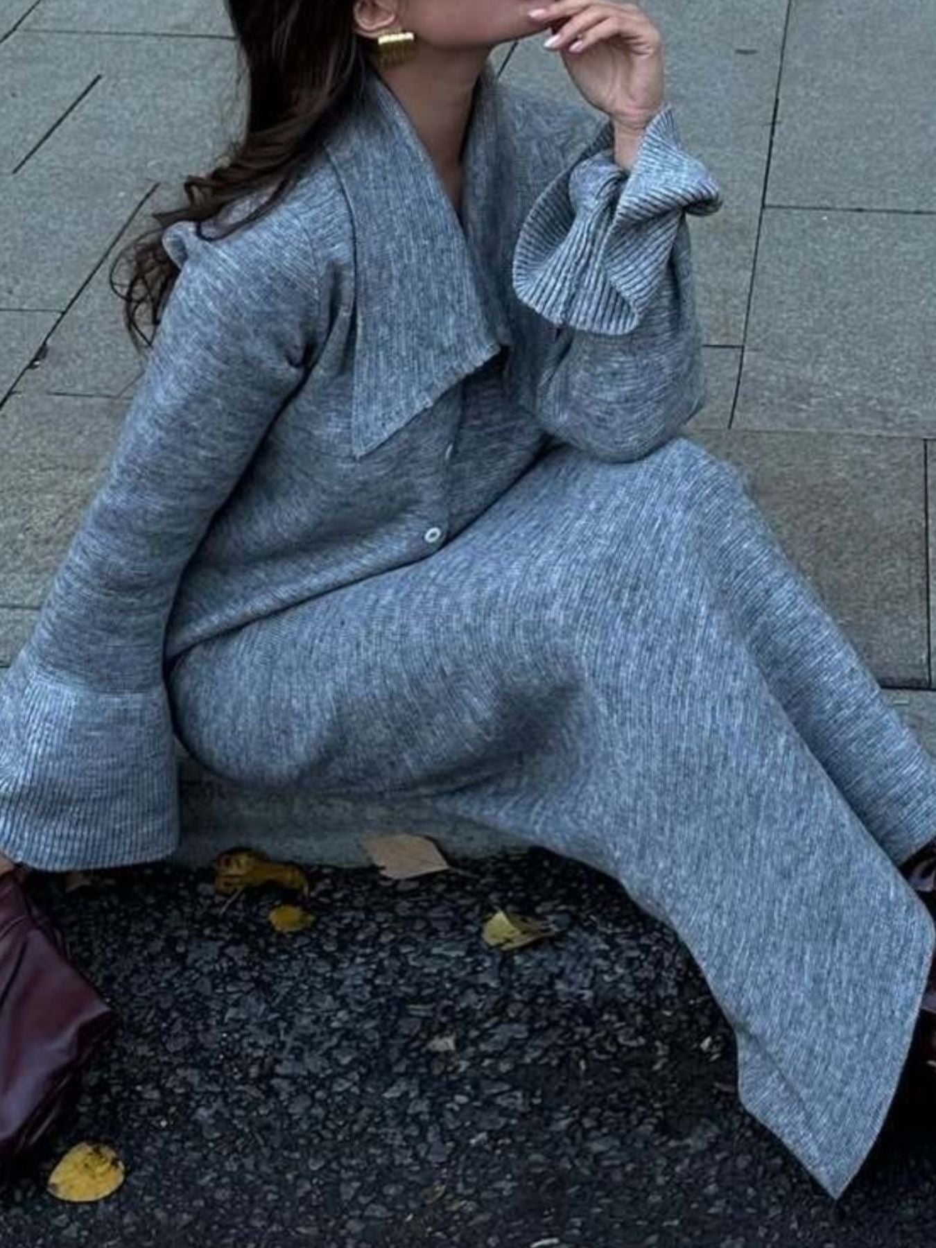 Grey ribbed knit cardigan and skirt set with bell sleeves and a collared neckline.