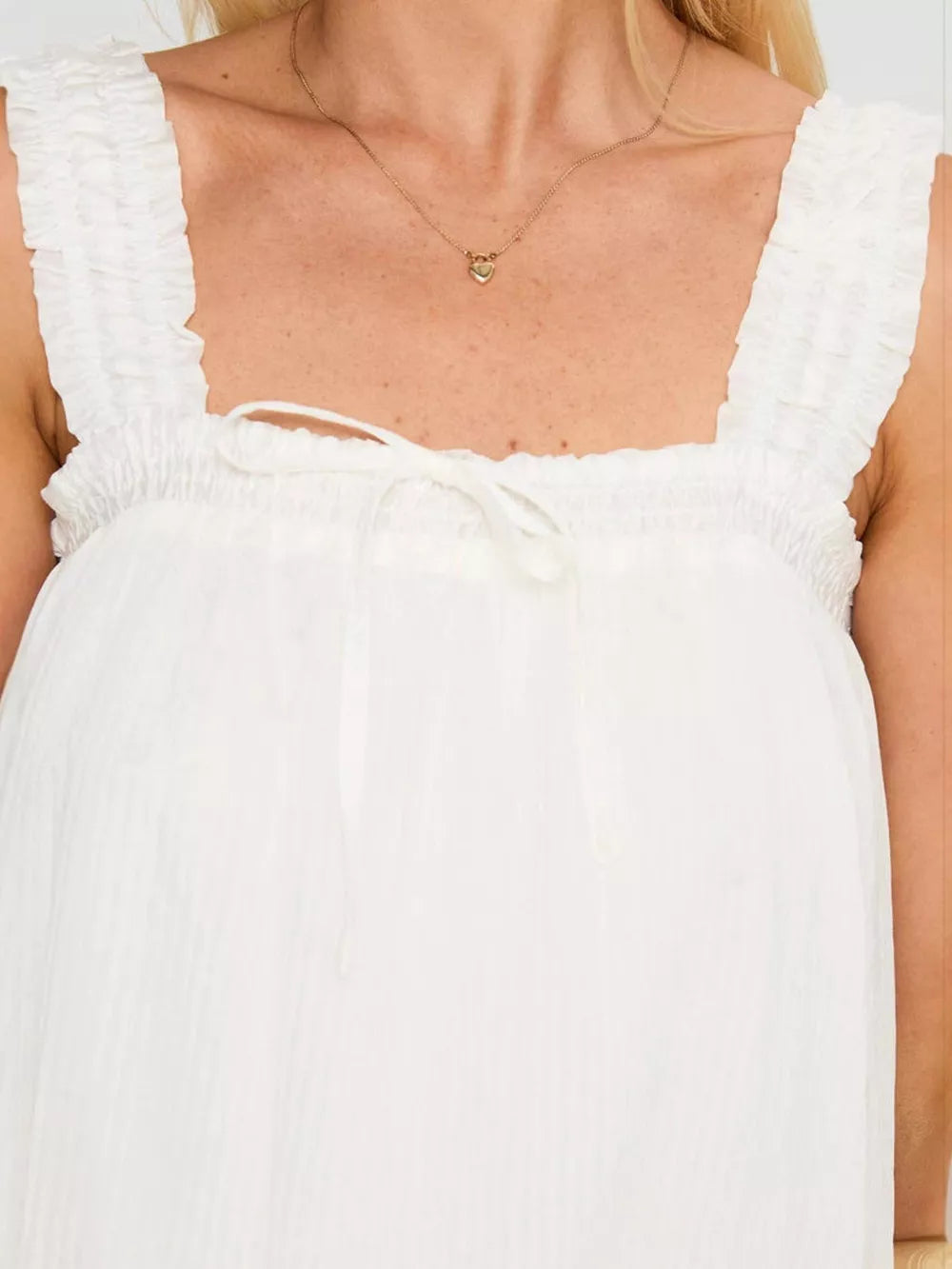 White frilled square neck mini dress with drawstring tie and ruffled straps.