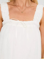 White frilled square neck mini dress with drawstring tie and ruffled straps.