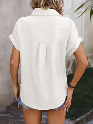 White textured button-down shirt with cuffed short sleeves and a back pleat detail.