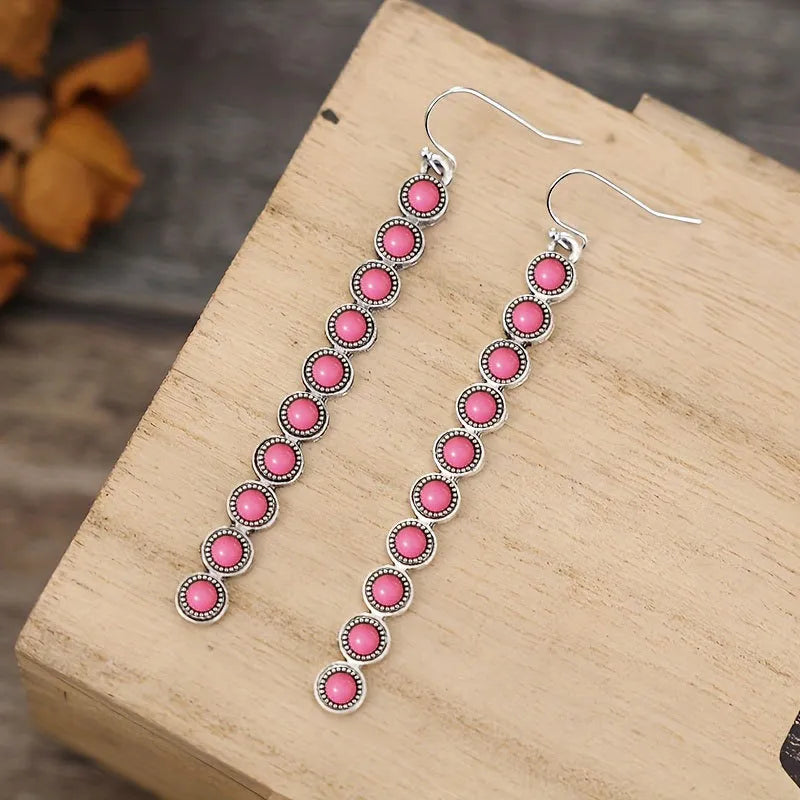 Linear drop earrings with pink stones and silver alloy settings