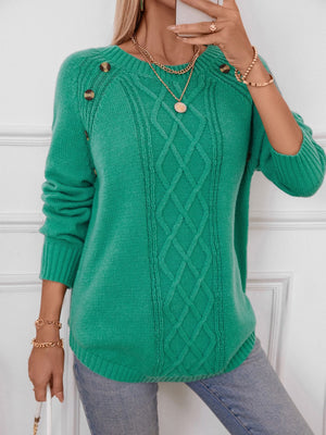 Green cable knit raglan sweater with button shoulder detail and crew neck.