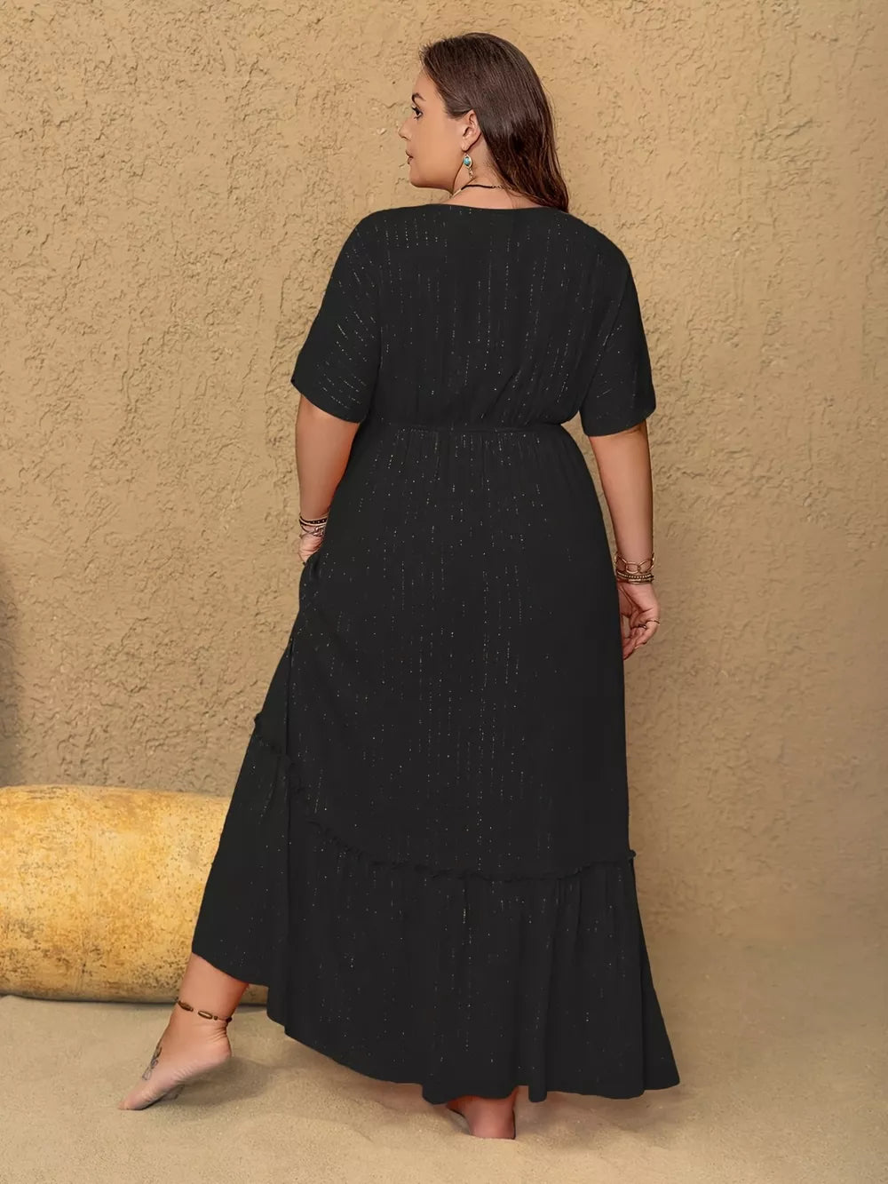 Plus size black V-neck maxi dress with metallic threads and tiered ruffle hem.