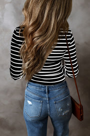 Black and white ribbed stripe long sleeve henley top with a crew neck.