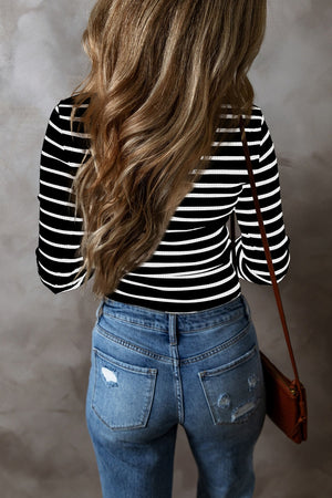 Black and white ribbed stripe long sleeve henley top with a crew neck.