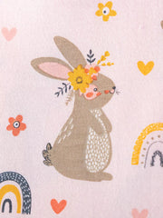 Baby dress in pink cotton with playful bunny, rainbow, and heart print.