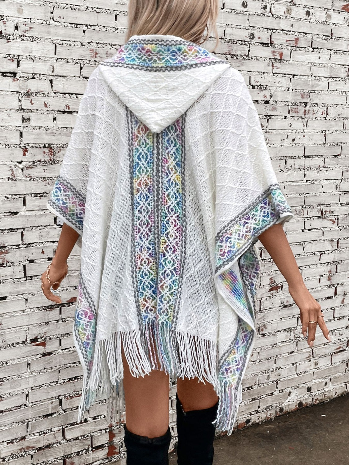 White knit hooded wrap coat with colorful embroidered trim and fringe detail