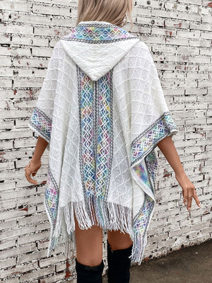 White knit hooded wrap coat with colorful embroidered trim and fringe detail
