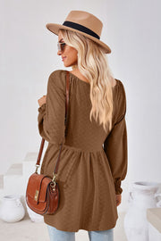 Brown textured babydoll blouse with smocked cuffs and square neckline.