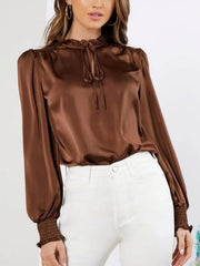 Brown satin tie-neck blouse with ruffled collar and shirred cuffs