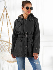 Black belted utility parka with faux fur hood trim and button flap pockets.