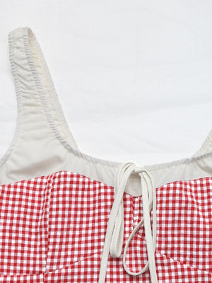 Gingham tie-front bustier top in deep red with white lining and ruched straps.