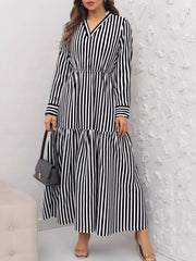 Notched long-sleeve midi dress in black and white stripes with a tiered skirt.