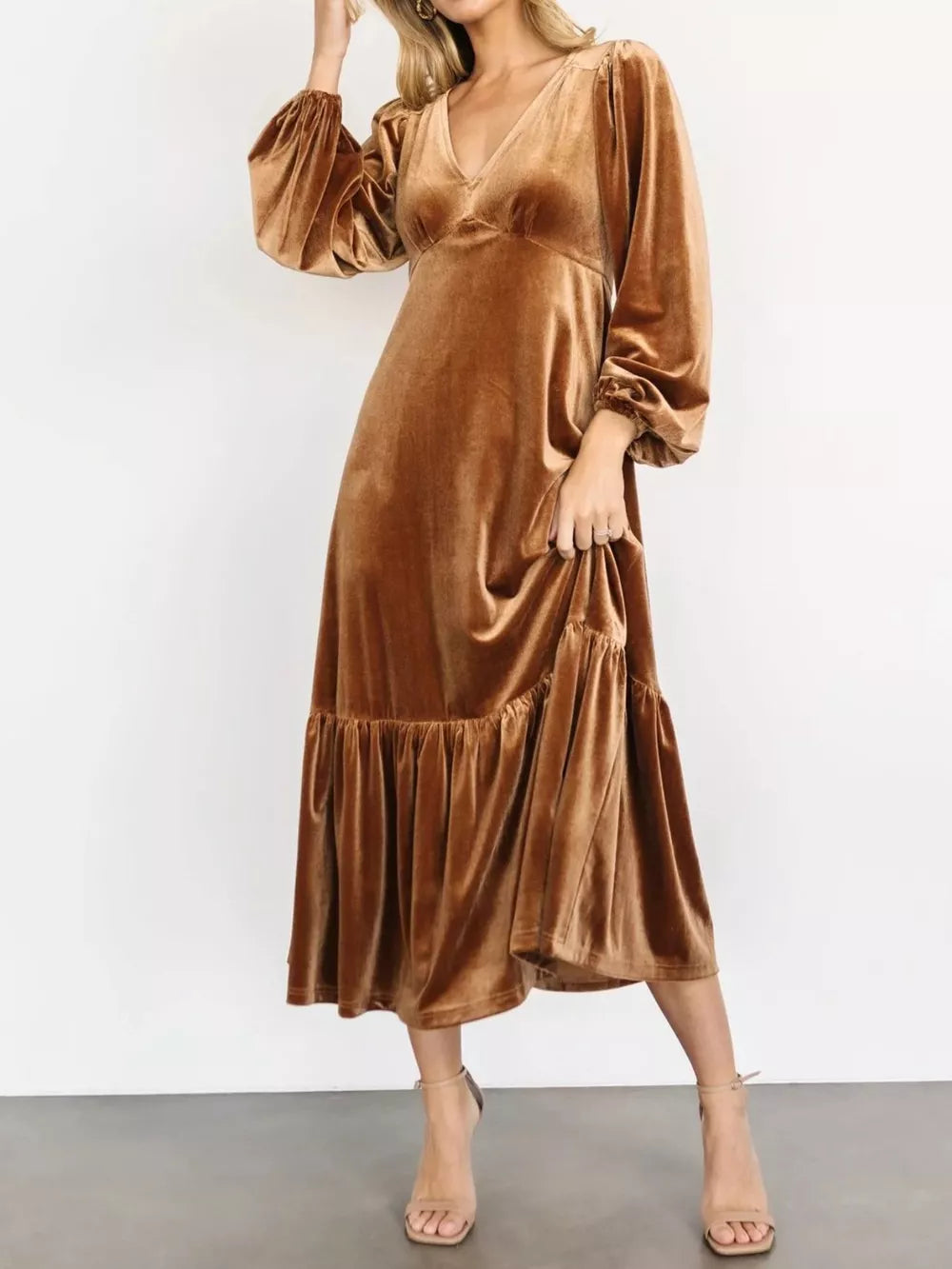 Gold velvet midi dress with tiered skirt, V-neck, and bishop sleeves.