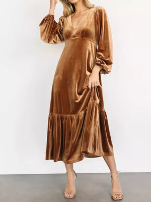 Gold velvet midi dress with tiered skirt, V-neck, and bishop sleeves.