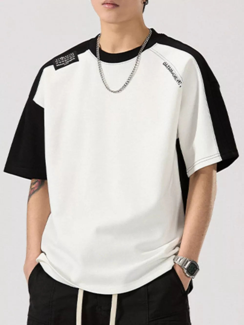 Color block t-shirt with black sleeves and white body, round neck, cotton blend.