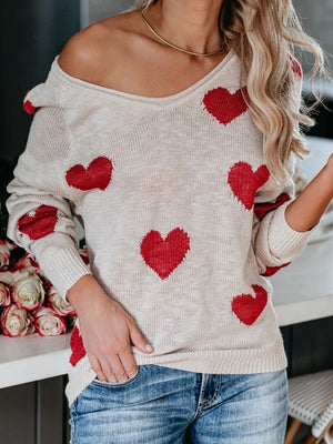Eggshell knit sweater with red heart motif, off-the-shoulder neckline, and long sleeves.