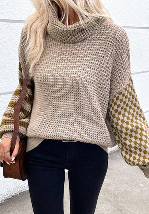 Turtleneck sweater in mocha with checkerboard and stripe sleeves.