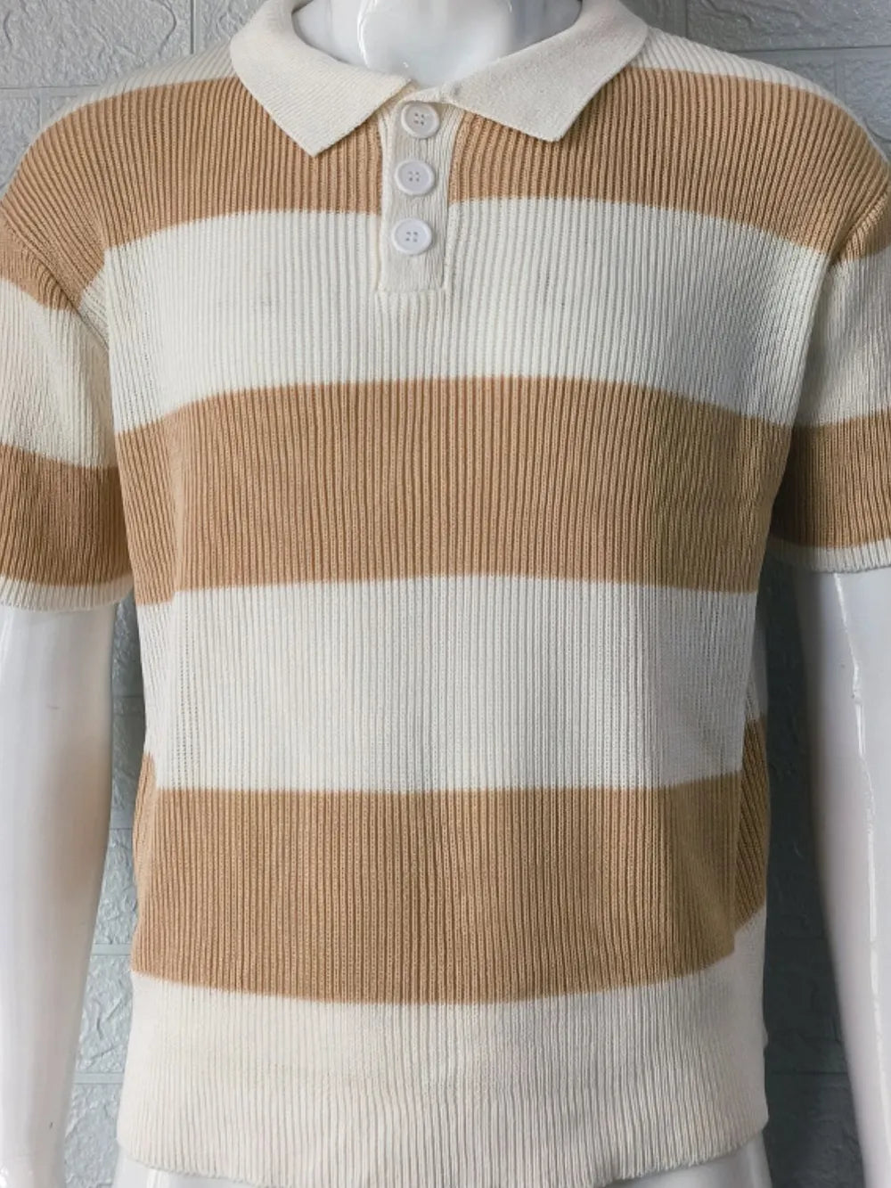 Brown and white striped ribbed knit polo shirt with short sleeves and a button placket.