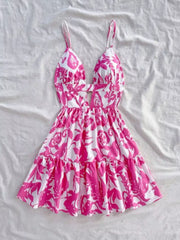 Vibrant floral cutout mini dress with tiered ruffle hem and spaghetti straps.