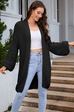 Black textured knit cocoon cardigan with balloon sleeves, open front, and relaxed fit.