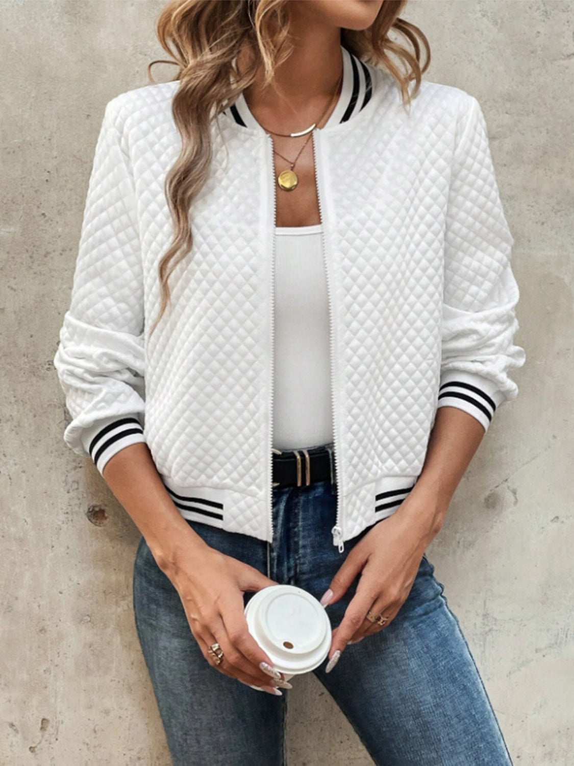 White quilted bomber jacket with striped ribbing at collar, cuffs, and hem.