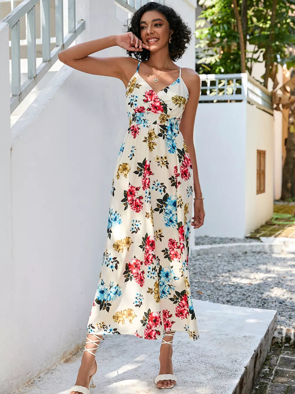 Chic floral midi dress with spaghetti straps and a V-neck in cream with red, blue, and gold flowers.