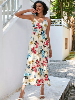 Chic floral midi dress with spaghetti straps and a V-neck in cream with red, blue, and gold flowers.
