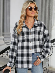 Black and white checkered collared long sleeve shirt with button front and chest pockets.