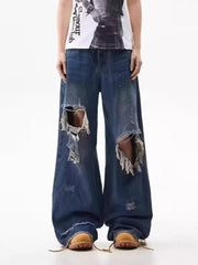 Men's distressed wide-leg jeans in dark wash denim with large rips.
