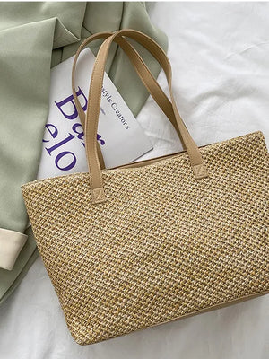 Textured straw shopper bag in beige with tan leather straps.
