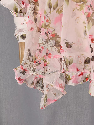 Charming ruffled floral mini dress in pink with a buttoned sleeve detail.