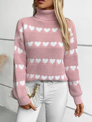 Pink turtleneck sweater with white heart intarsia pattern, acrylic knit, long sleeves.
