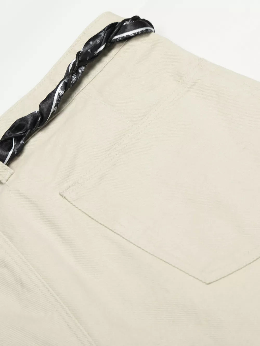 Cream white maternity pants with a black paisley print braided belt detail.