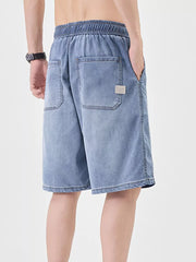 Casual loose fit denim shorts for him in light blue with elastic waistband and back pockets.